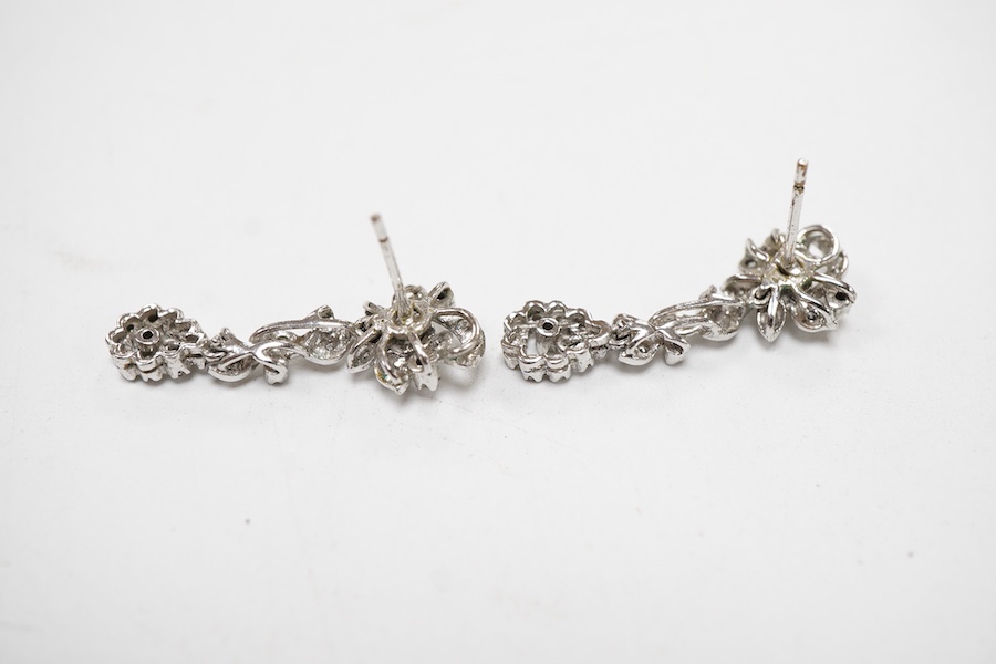 A pair of recent white metal and diamond cluster set drop earrings, of foliate design with pear shaped drops, overall 29mm.